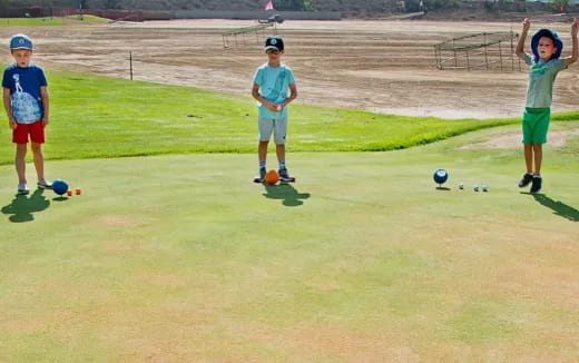 a group of kids playing with balls