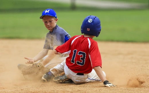 a couple of baseball players on the ground