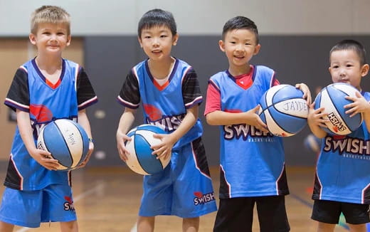 a group of boys holding balls