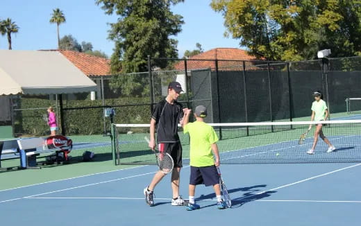 a group of people play tennis