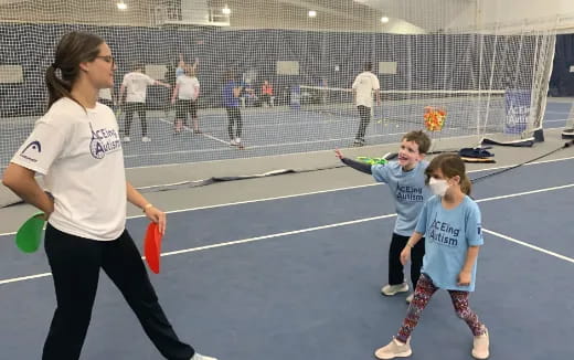 a person and two children on a court