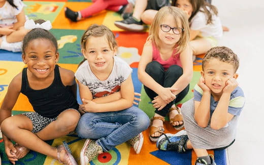 a group of children sitting on the floor