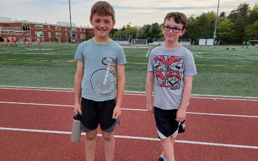 two boys standing on a track