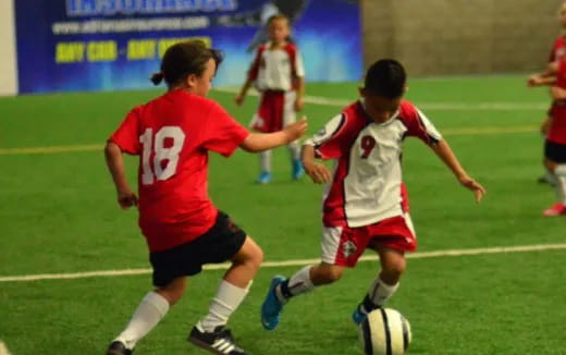 a group of kids playing football