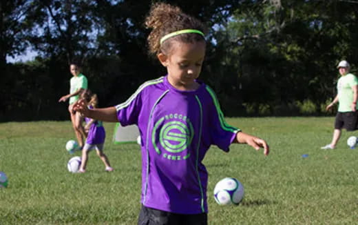 a young girl playing football