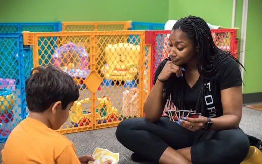 a person and a boy sitting on the floor