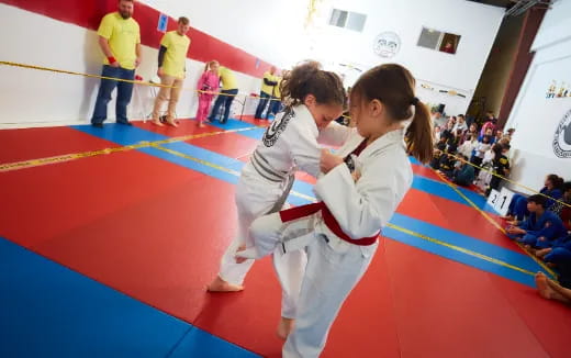 a couple of children in karate uniforms