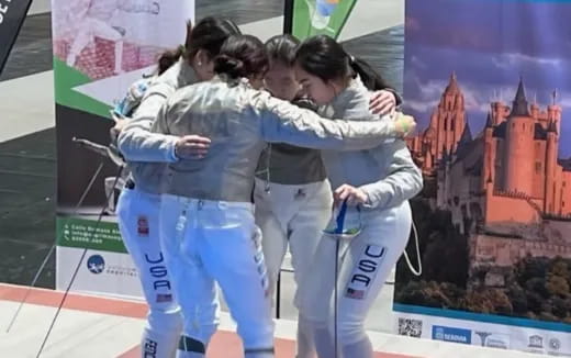 a group of people in white karate uniforms hugging
