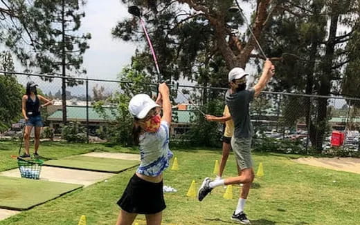 a group of people playing golf