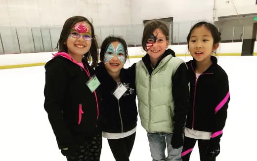 a group of girls with face paint