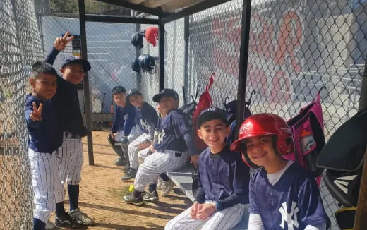 a group of kids in a batting cage