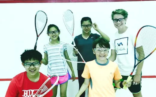 a group of people holding tennis rackets