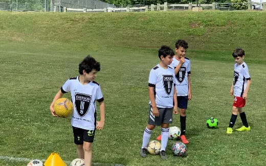 a group of kids playing football