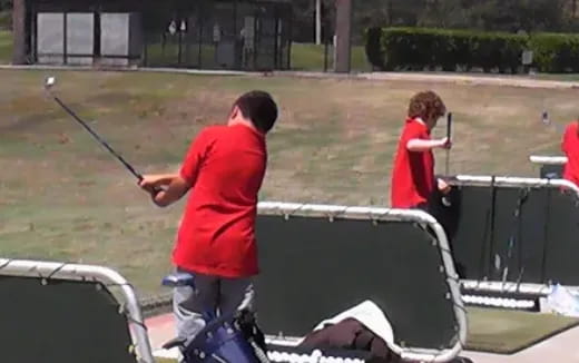 a man and a woman playing golf