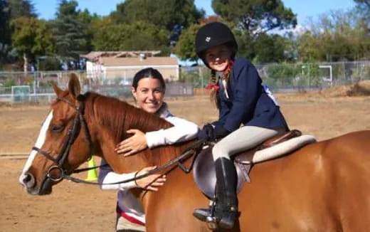 a man and a woman riding horses