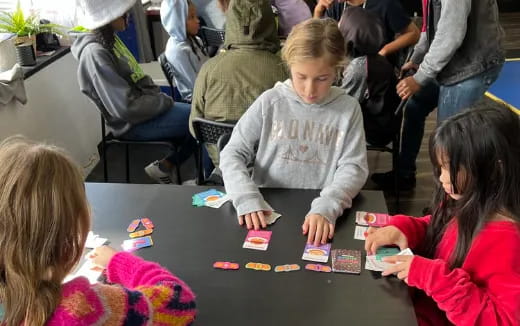 a group of children playing a board game