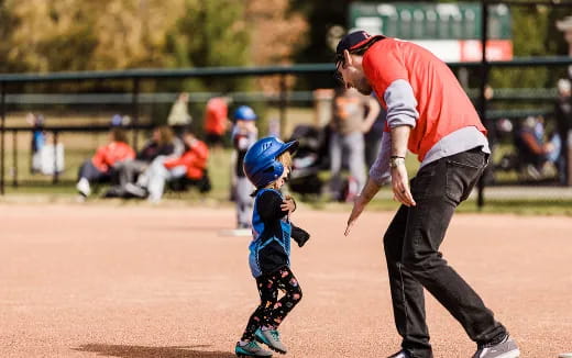 a man and a child playing baseball