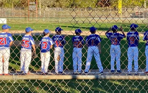 a group of baseball players standing on a field