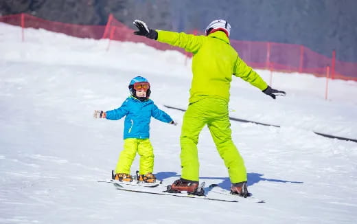 a person and a child skiing