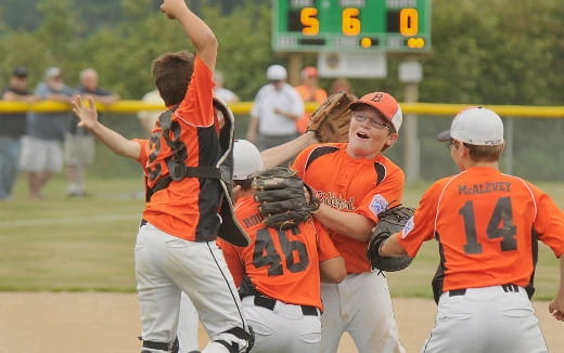 a group of people playing baseball