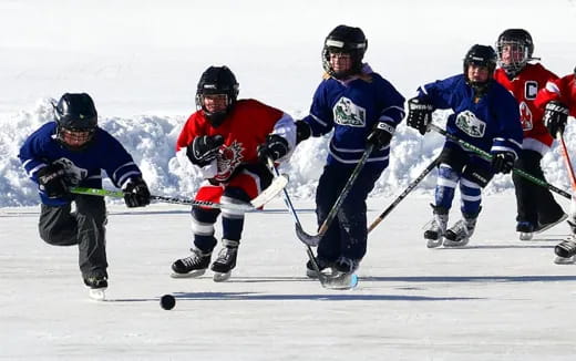 a group of people playing hockey