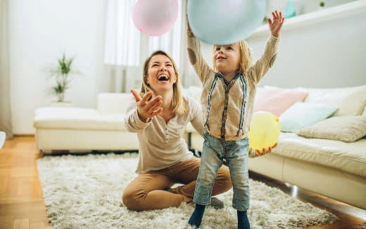 a couple of girls holding balloons