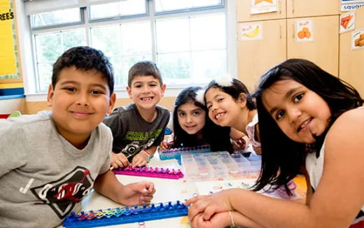 a group of children sitting at a table