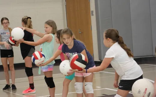 a group of girls playing volleyball