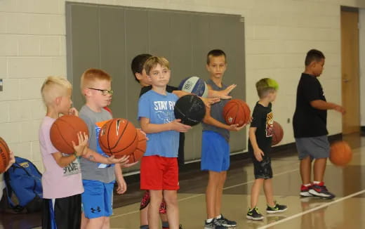 a group of kids holding basketballs