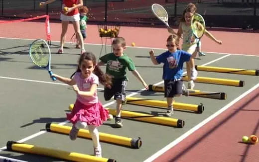 kids playing tennis on court