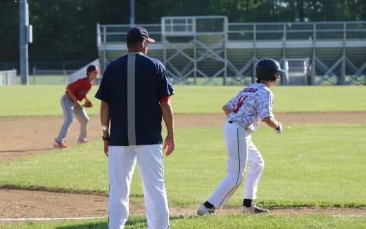 a person and a kid on a baseball field