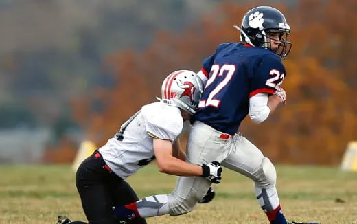 a couple of men playing football