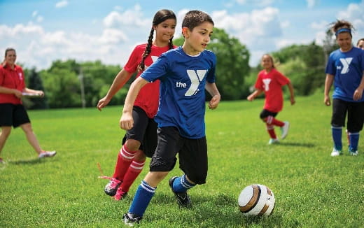 a group of kids playing football