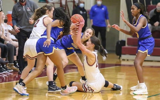 a group of women playing basketball