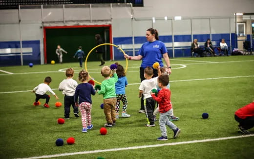 a group of kids playing with balls