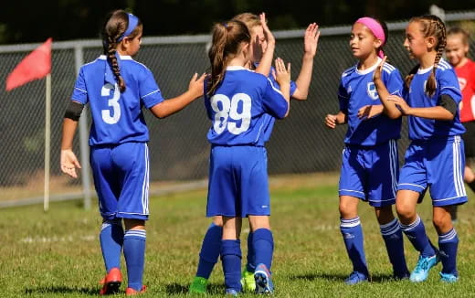 a group of girls in blue uniforms