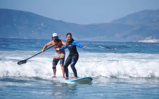 a person and a boy surfing