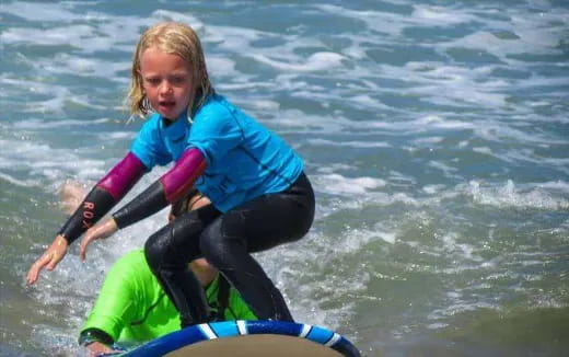 a girl riding a surfboard
