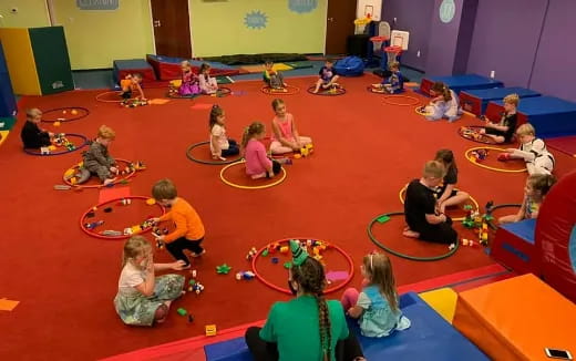 a group of children sitting on mats