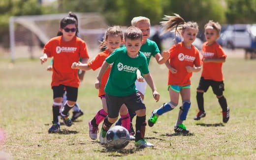 a group of kids playing football