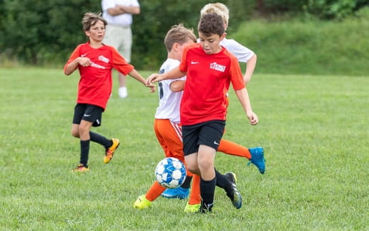 a group of kids playing football