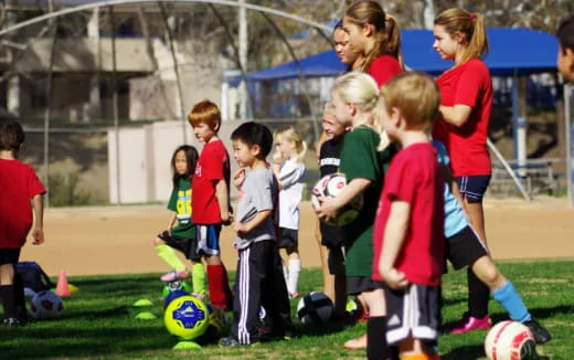 a group of kids playing football