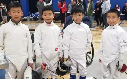 a group of boys in white uniforms