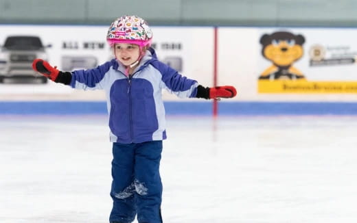 a child on ice with a toy