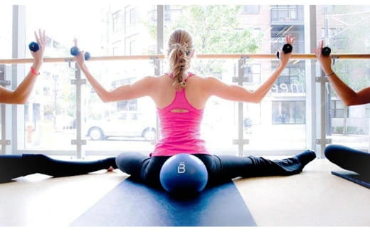 a woman exercising on a yoga mat