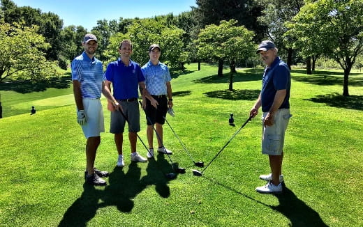 a group of men on a golf course