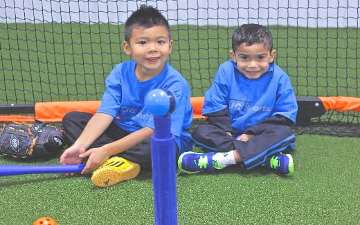 two boys sitting on a playground