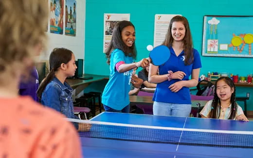 a group of girls playing ping pong