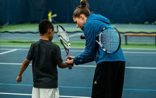 a couple of people stand on a tennis court