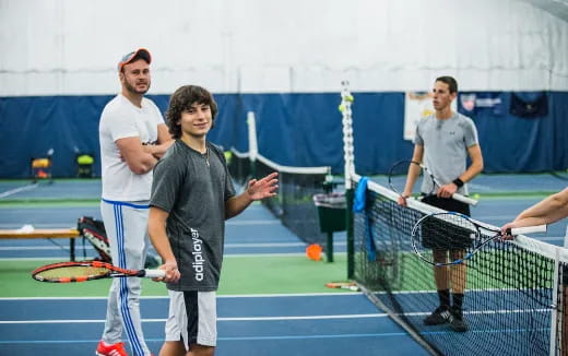 a group of men holding tennis rackets